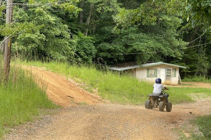 a person riding a motorcycle down a dirt road